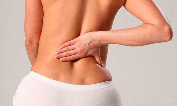 Back pain in the lumbar region of a woman
